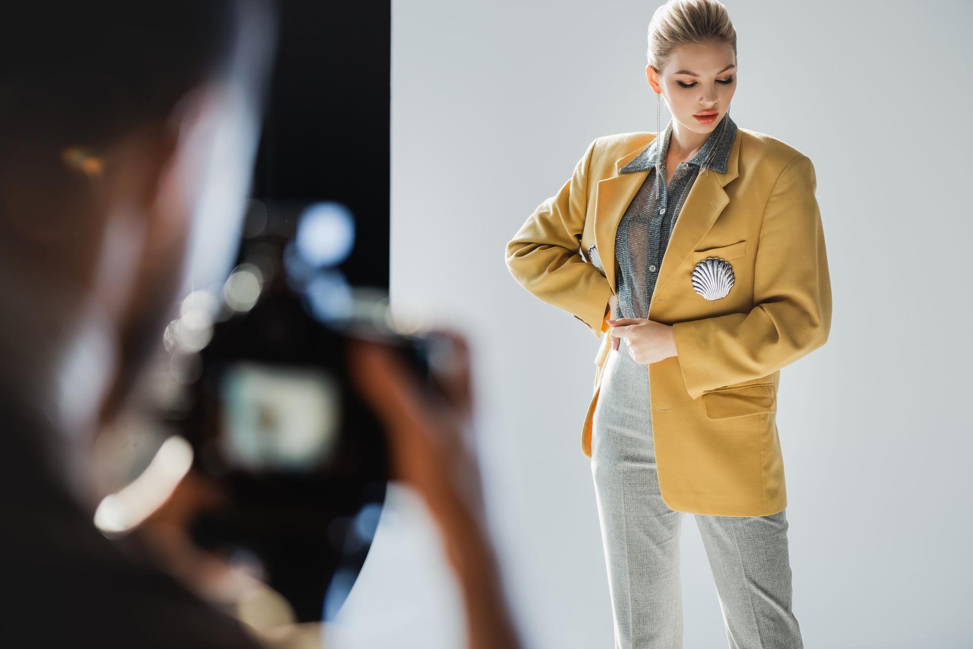 selective focus of stylish model posing for photographer
